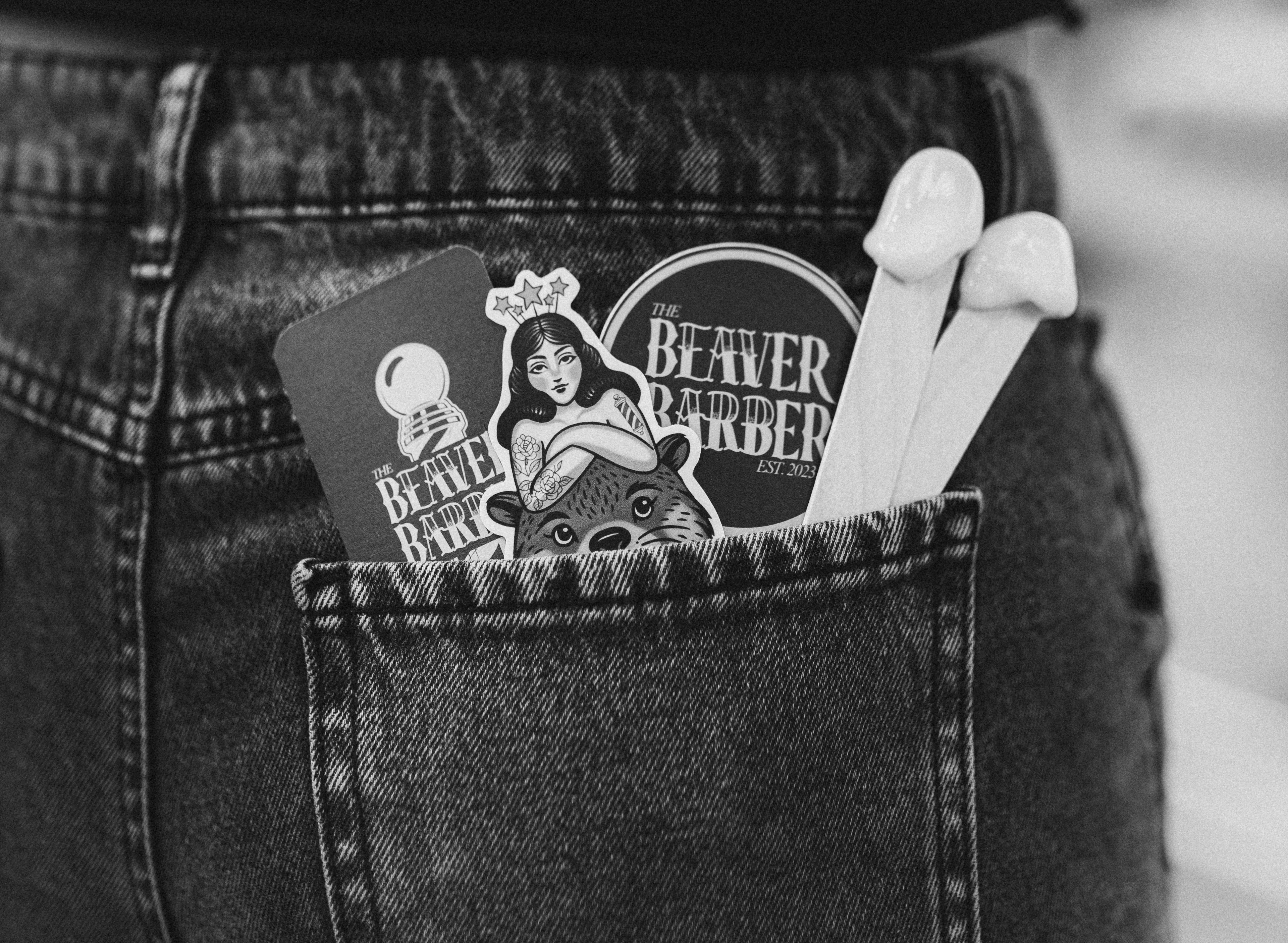 Person wearing a black shirt with a visible brand logo on the back pocket.